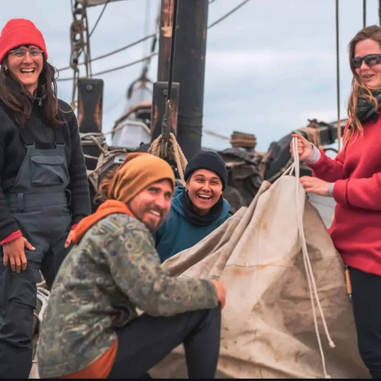 Grayhound crew setting sails, smiling at the camera.